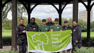 Seven members of the ground maintenance and security team at Paddington Recreation Ground holding their 2021 green flag
