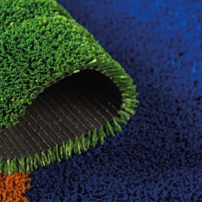 close-up image of articifical turf surface filled over with sand and coloured blue