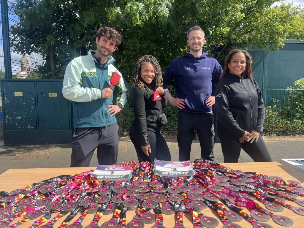 AW, London Marathon Events & EA Team members holding up medals